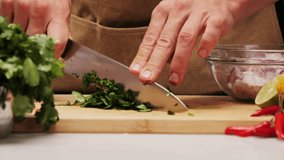 Cilantro parsley cutting by knife close up, chef chop cut coriander aromatic, traditional asian and Mexican cuisine herb studio shot. - Powered by Shutterstock - Get 15% off with code: PIKWIZARD15