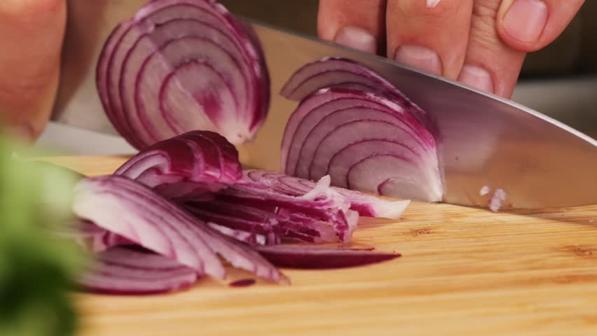 Chef Cutting Red Onions on a Kitchen Board to Add Freshness and Flavor to a Delicious Recipe of seviche