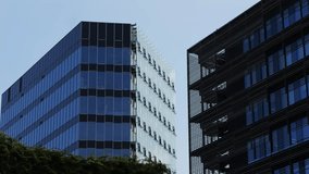 Modern glass office scyscraper buildings beautifully reflecting the clear blue sky in an urban environment - Powered by Shutterstock - Get 15% off with code: PIKWIZARD15