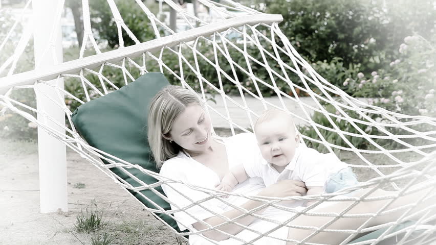 Happy baby with mother in hammock   