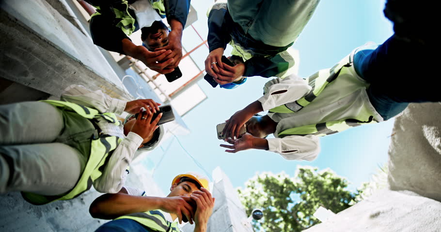 Phone, engineer team and people planning construction project, infrastructure development or site maintenance. Architect, mobile or group work by building in collaboration or discussion below outdoor