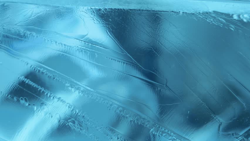 Macro shot of ice in a blue winter sky. Close-up of an icy surface.