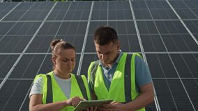 Professional Engineers Configuring Solar Panels with Tablet Technology for Renewable Energy Generation and Eco-Friendly Power Solutions. High quality 4k footage - Powered by Shutterstock - Get 15% off with code: PIKWIZARD15