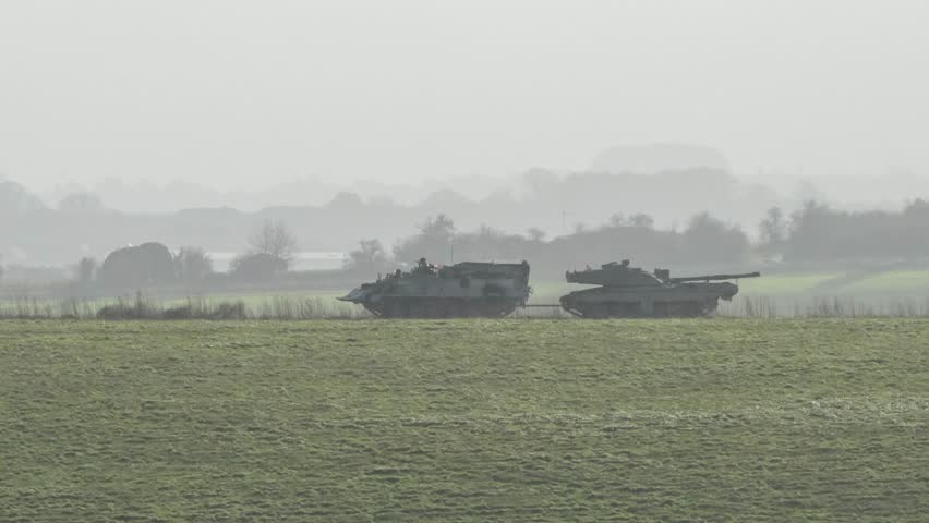 British Army Challenger 2 ii Tank Armored Repair and Recovery Vehicle (CRARRV) towing a Challenger ii 2 FV4034 main battle tank in pouring rain