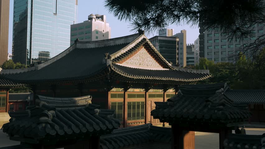 Deokhongjeon Hall With High-rise Buildings In The Background At Deoksugung Palace In Seoul, South Korea. - slider, reveal shot
