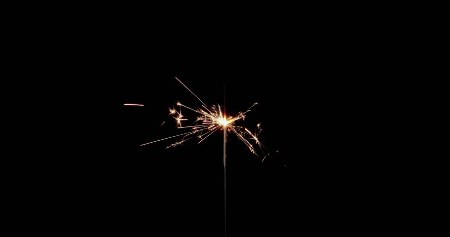 Lightening sparkler on the black background. Sparkler concept. Bengal lights are burning on a black background. Holiday party concept. New year party sparkler. Slow motion.