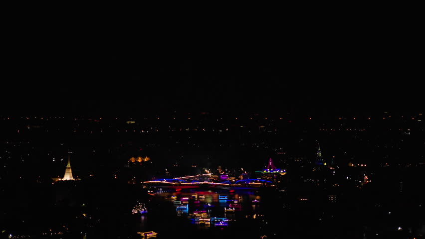 Powerful large-scale grandiose flash lights fireworks sparks explosions in the sky among buildings skyscrapers night city, Firework display and light show at Bangkok’s River to promote tourism