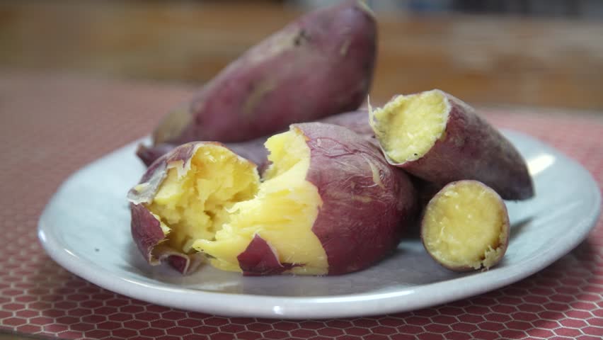 Steaming roasted sweet potato on a plate
