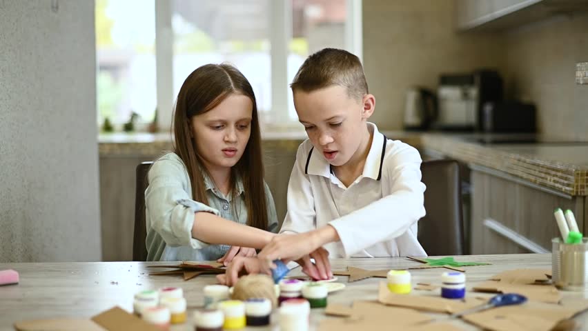 Kids create and paint handmade ornaments stars. Eco-friendly Christmas decorations. Recycling carton, reuse cardboard