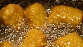 Closeup slow motion crispy fried chicken meat nuggets deep frying in boiling oil - Powered by Shutterstock - Get 15% off with code: PIKWIZARD15