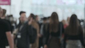 Abstract image of people at a technology conference. Busy atmosphere, highlighting business networking and communication. - Powered by Shutterstock - Get 15% off with code: PIKWIZARD15