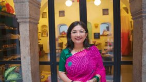 Portrait of Indian teenager girl wearing traditional saree speaking at camera and doing namaste gesture. Girl vlogging and creating content for social media. - Powered by Shutterstock - Get 15% off with code: PIKWIZARD15