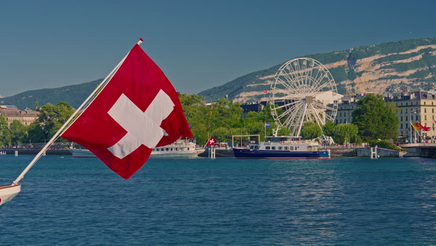 Swiss flag against a blue clear sky in a summer day in Switzerland