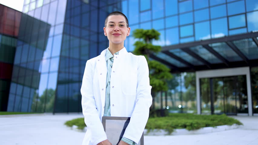 Happy, young female doctor enjoying outdoors