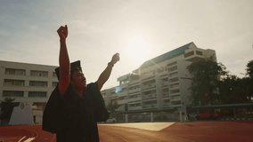 A graduate is standing in front of a building with a diploma in his hand. Scene is celebratory and triumphant - Powered by Shutterstock - Get 15% off with code: PIKWIZARD15