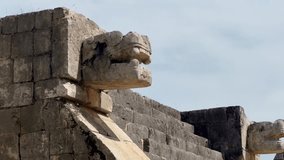 Handheld close-up panning shot of jaguar stone carvings to the Pyramid of Kukulkan in Chichen Itza, Mexico. 4K - Powered by Shutterstock - Get 15% off with code: PIKWIZARD15