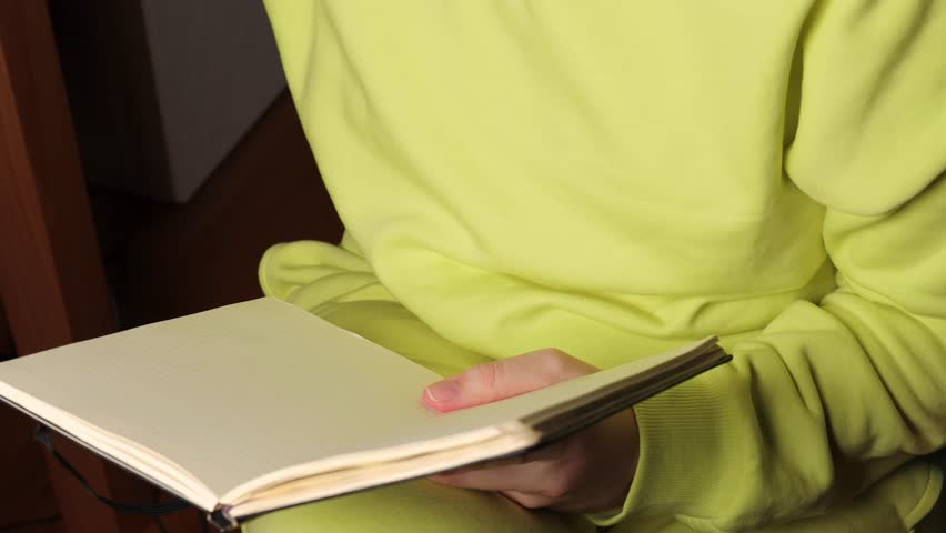 woman writing next year’s goals with pen. concept of future aspirations, personal development, planning, motivation, and goal setting