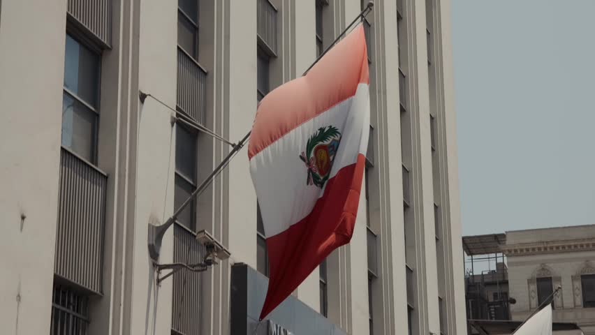 Waving National Flag Of Peru In The Facade Of A Building In Lima Province. Static Shot