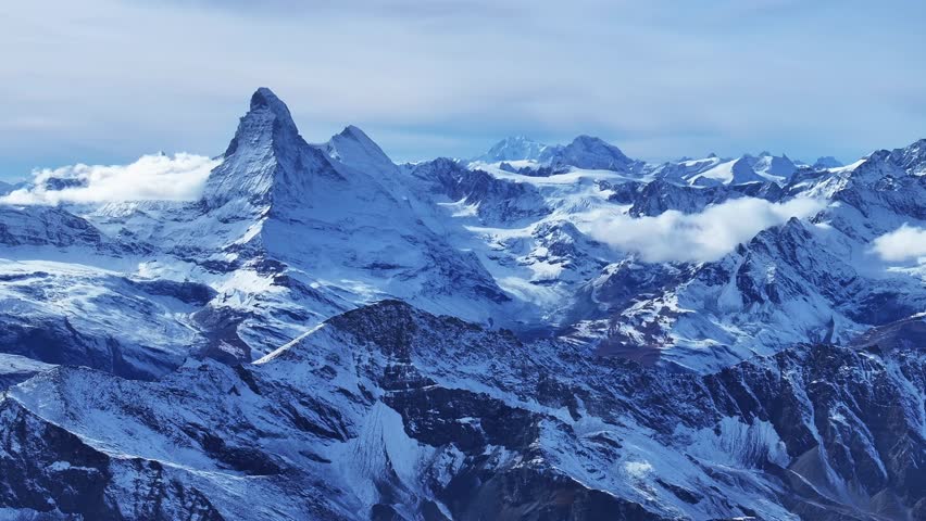 Matterhorn Zermatt Saas Fee Saastal Swiss Alps aerial drone glacier parallax right zoom motion glacial glacier crevasse autumn fresh snow unique vista scenic landscape Gornergrat railway blue sky