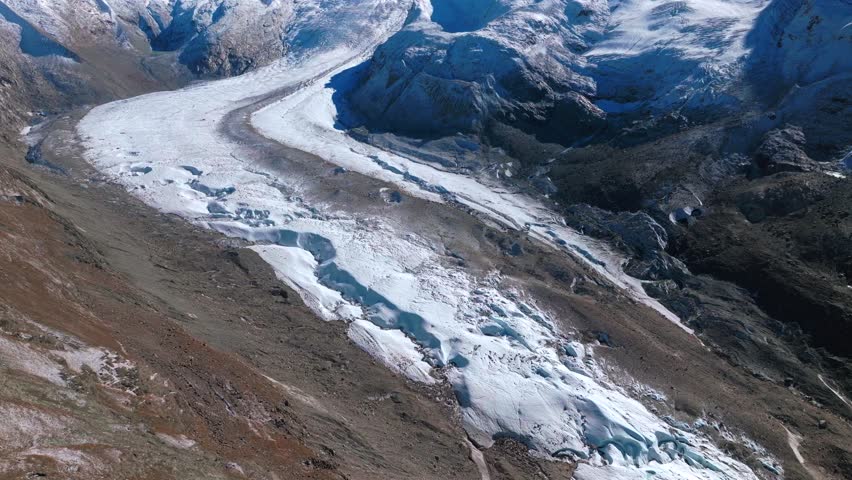 Zermatt Saastal Saas Fee Swiss Alps glacial river glacier crevasse Matterhorn Valley aerial drone first snow fall autumn blue skies early morning Gornergrat railway mountain peaks forward pan up