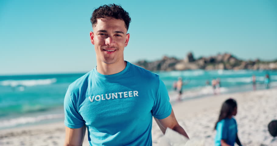 Volunteer, cleaning or face with plastic bag at beach for ocean cleanup, waste management or sustainability. NGO project, man or happy with community service for environment conservation or earth day