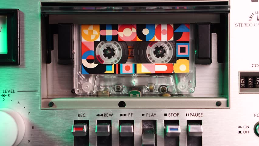 Old Analog Audio Cassette Tape Playing in Deck Player From 1980s, Close Up