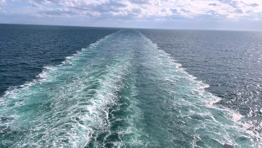 large ship travelling the English channel. Blue water giving rise to a white wake