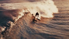 Surfer aerial. Surfer rides the wave in the Maldives. Aerial view of the rider on a wave during golden sunset - Powered by Shutterstock - Get 15% off with code: PIKWIZARD15
