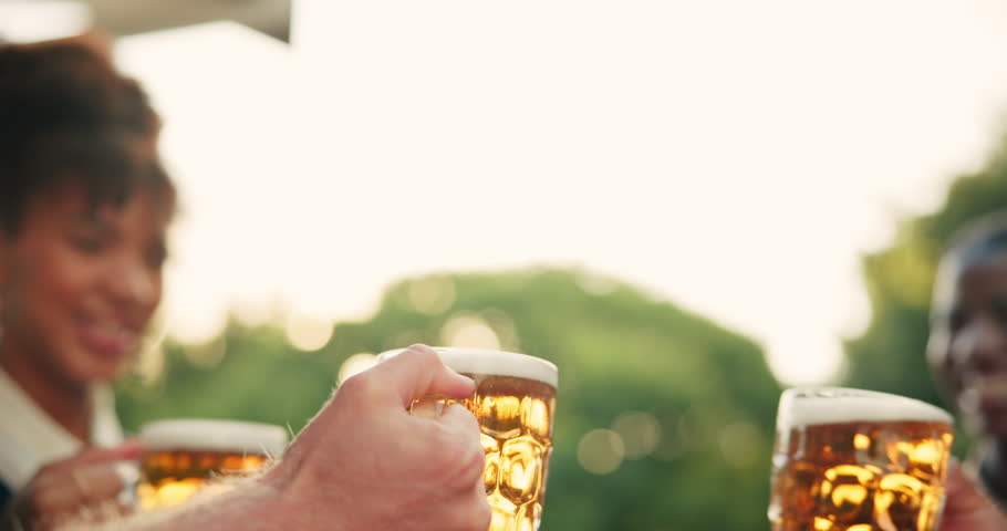 Outdoor, friends and alcohol with cheers for celebration, having fun and bonding together by bokeh. Group of people, hands and glasses of beer for toast, solidarity and liquor beverage for reunion