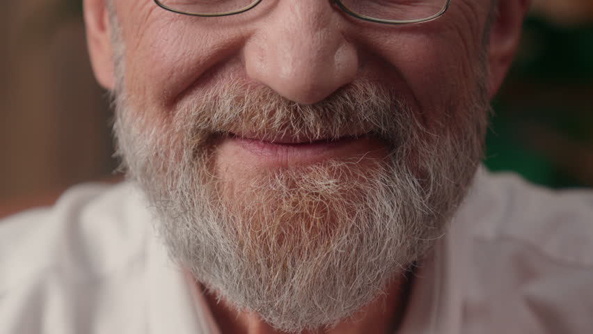 Close up cropped view half face old happy Caucasian man senior smiling elder pensioner wrinkled male grey beard mouth smile health wellbeing medicine lips indoor glad retired businessman business home