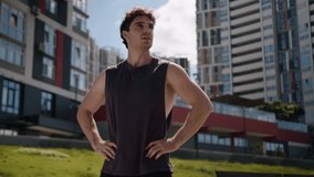 Confident Caucasian man hands on hips accomplishment achievement proud sportsman athlete male endurance strong motivation sport guy standing active training workout posing exercise urban city outdoor - Powered by Shutterstock - Get 15% off with code: PIKWIZARD15