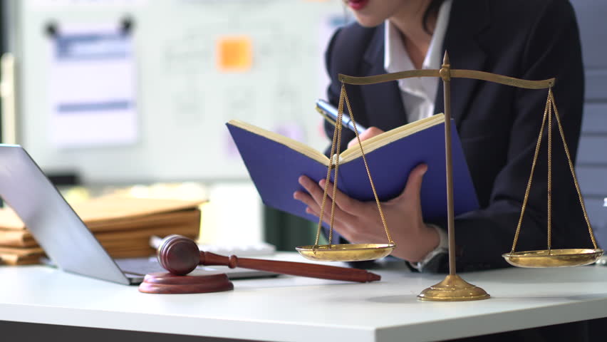 Lawyer business woman working with paperwork on his desk in office workplace for consultant lawyer in office.
