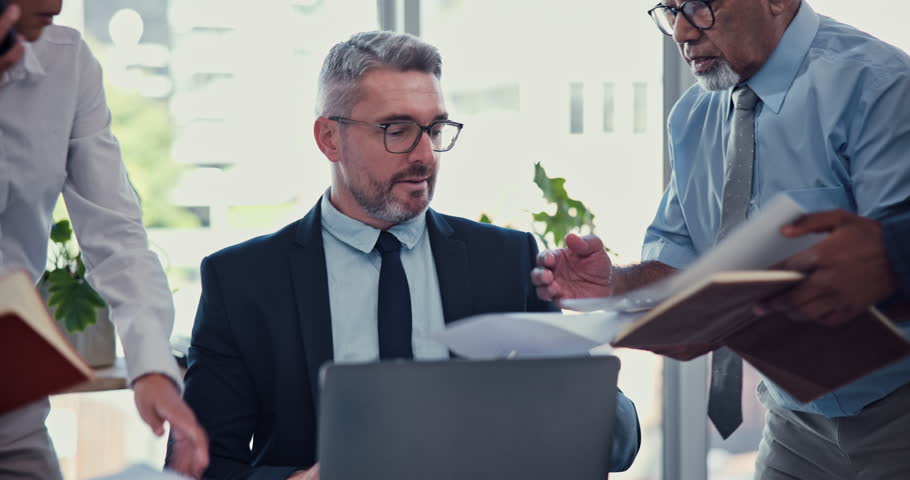 Office, colleagues and businessman with phone call for multitasking, chaos or anxiety for workload. Staff, mature lawyer and stress with paper for deadline, law firm or pressure for corporate project