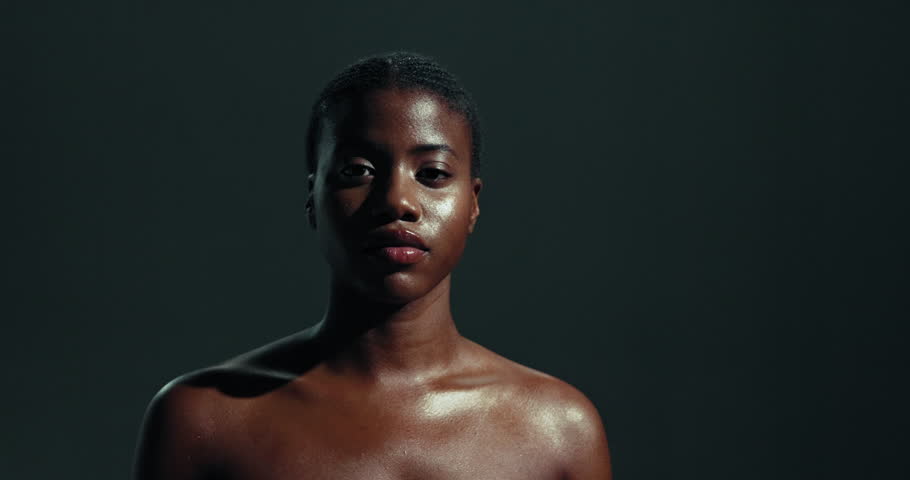 Face, beauty and skincare with black woman in studio for shine, dermatology and aesthetic. Self care, cosmetics and salon with person on dark background for collagen benefits, wellness and glow