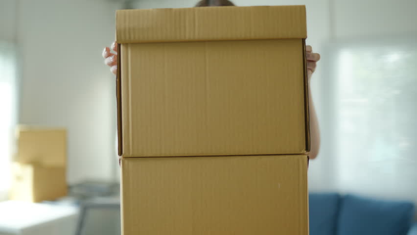 Famale Owner SME Small and Medium Enterprises woman received orders from clients and check profit on calculator preparing products in parcel cardboard box packaging at home ready for delivery