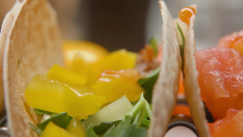 Sliced tomato falling on tortilla. High quality 4k footage