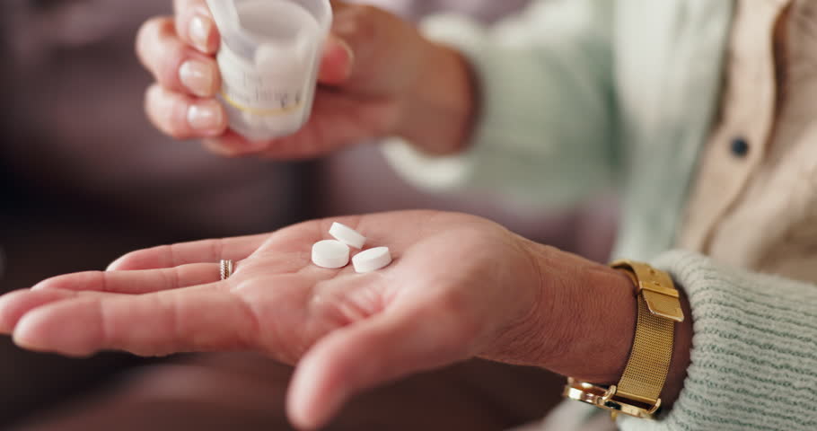 Old woman, hands and pill bottle in home, senior supplement and drugs for healthcare in lounge. Elderly person, capsules and treatment for arthritis or osteoporosis, tablets and palm in closeup