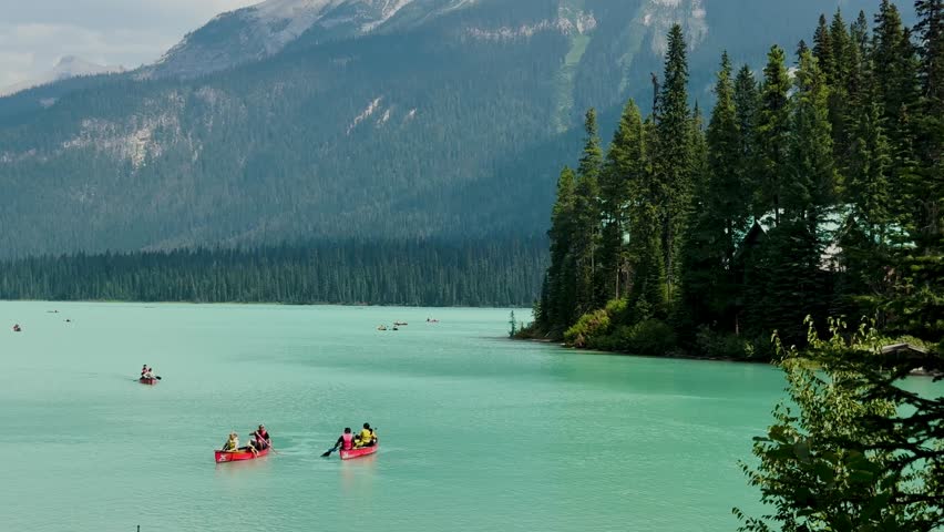 Emerald Lake is located in Yoho National Park in Canada. Famous for its emerald color and the splendid view of the Canadian Rockies that frame it. Canoe excursion with family. Trekking to the lake.
