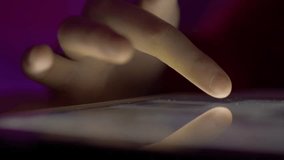 Girl Browsing Digital Tablet Computer With Finger at Night. Person Using Smartphone, Browsing on Social Network. Close-up Finger Scrolling Social Media App Feed or Reading News Feed Online.  - Powered by Shutterstock - Get 15% off with code: PIKWIZARD15