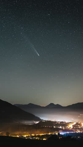 Comet Tsuchinshan Atlas in starry night sky over Europe countryside traffic Astronomy Time lapse Vertical video