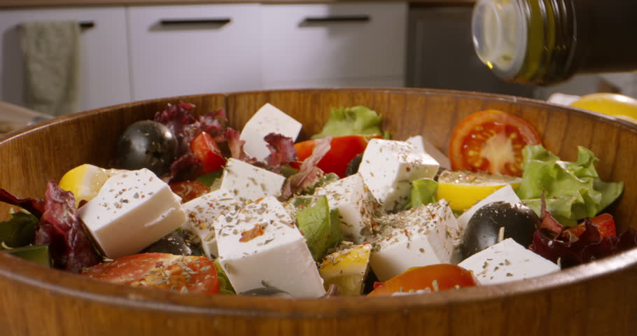 Healthy Lifestyle: Olive Oil Poured Over Vibrant Mediterranean Salad - healthy eating rich in nutrients, balanced Mediterranean diet concept close up 4k