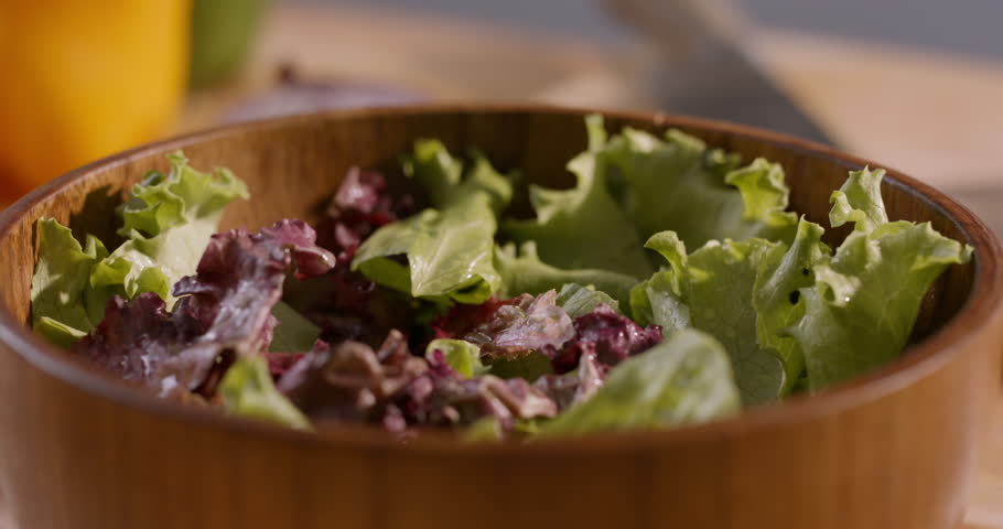 Appetizing Close-Up of Fresh Ingredients Falling into a Mediterranean Salad, Emphasizing Healthy Lifestyle and Wholesome Home Cooking
