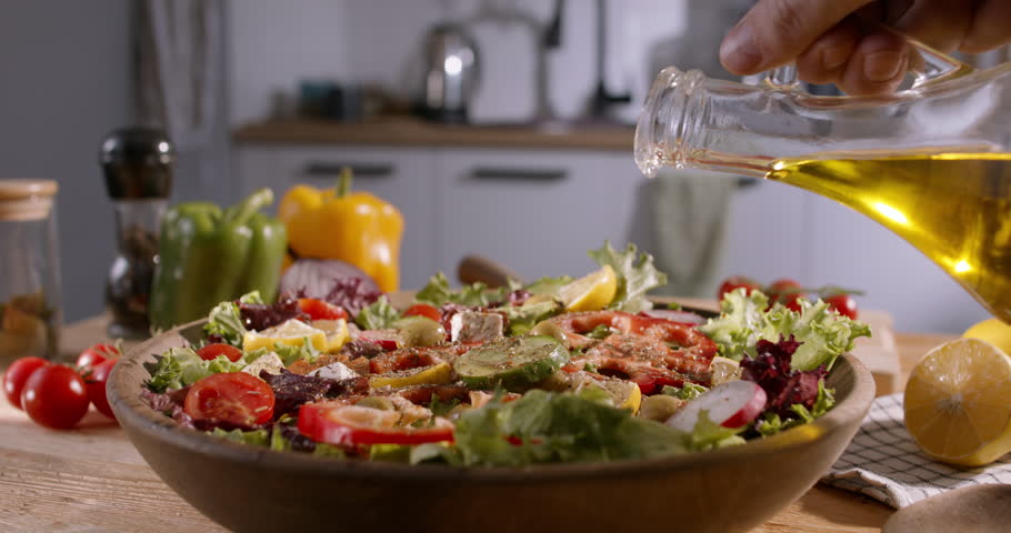Healthy Lifestyle: Olive Oil Poured Over Vibrant Mediterranean Salad - healthy eating rich in nutrients, balanced Mediterranean diet concept close up 4k