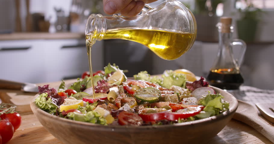 Healthy Lifestyle: Olive Oil Poured Over Vibrant Mediterranean Salad - healthy eating rich in nutrients, balanced Mediterranean diet concept close up 4k