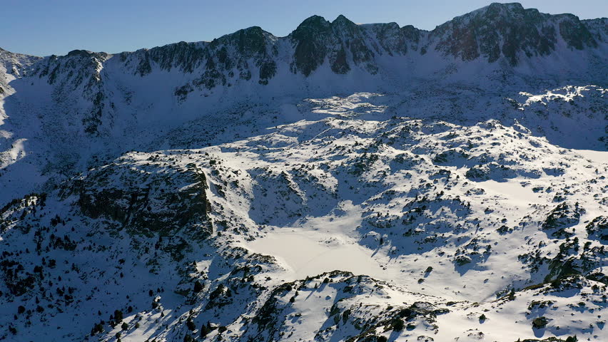 Aerial view of frozen lakes and forest of Ordino, a beautiful ski resort in the Pyrenees, Andorra.