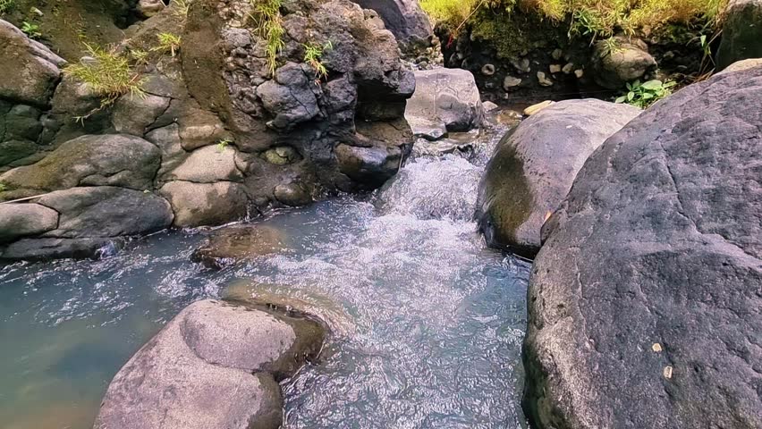 The rushing mountain water flows in the wild river