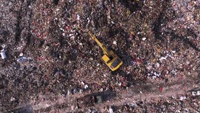 Thrash truck deliver garbage to landfill full of thrash and plastic. Top-down aerial view of an excavator operating on a dump, surrounded by waste piles. Environment damage - Powered by Shutterstock - Get 15% off with code: PIKWIZARD15