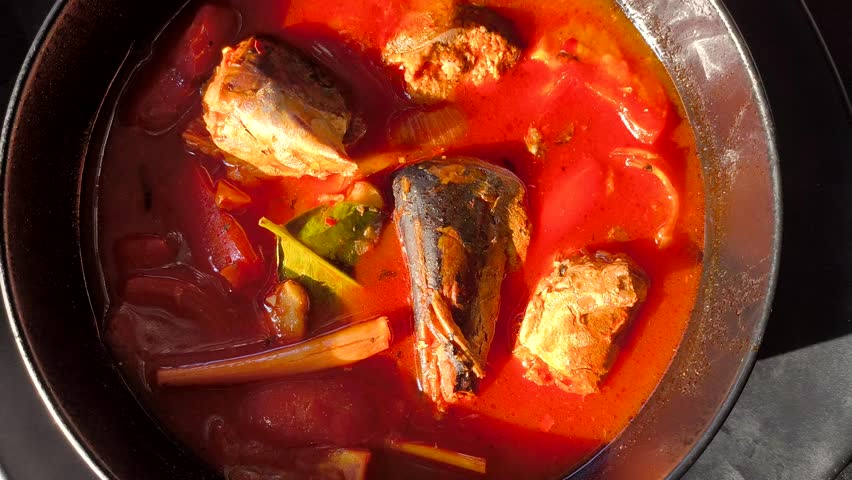 Spicy fish soup or Tom Yum in bowl, in door  Chiangmai  Thailand.