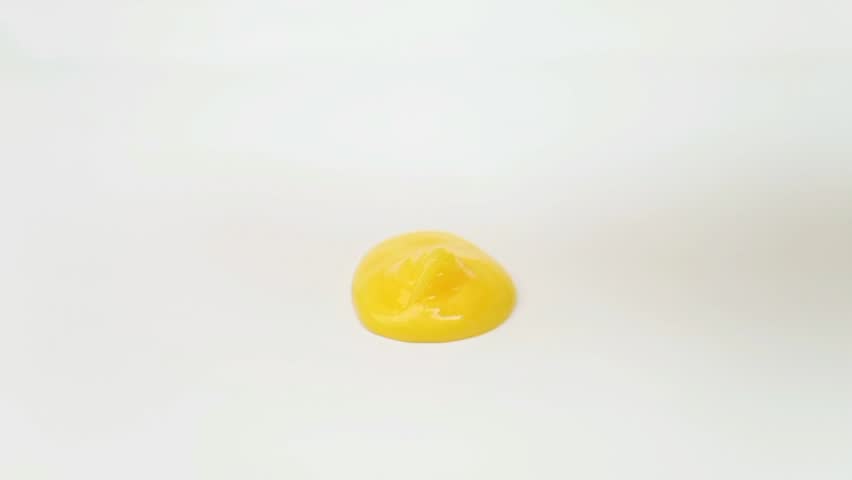 Yellow liquid texture face wash, shampoo, cleanser, cosmetic or skincare product dropping on white background.