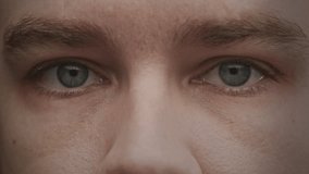 Close-up of eyes opening slowly and looking directly at the camera - Powered by Shutterstock - Get 15% off with code: PIKWIZARD15